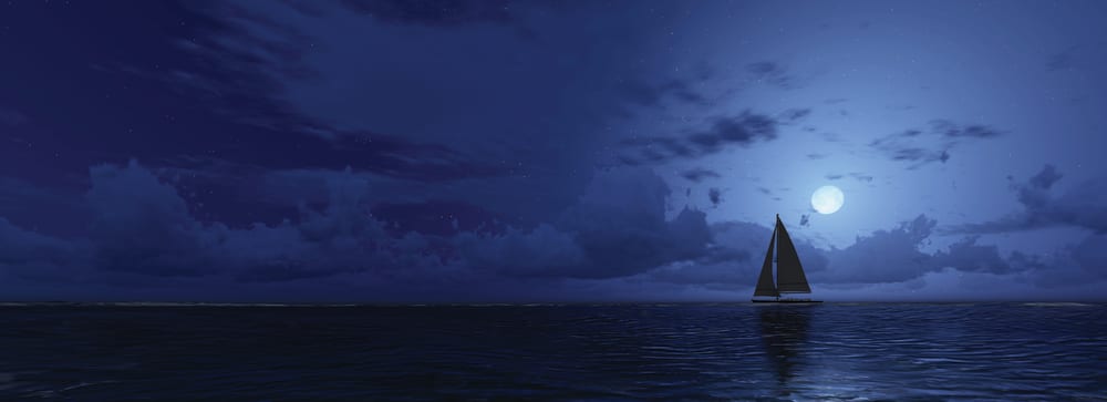 Boat sailing under full moon