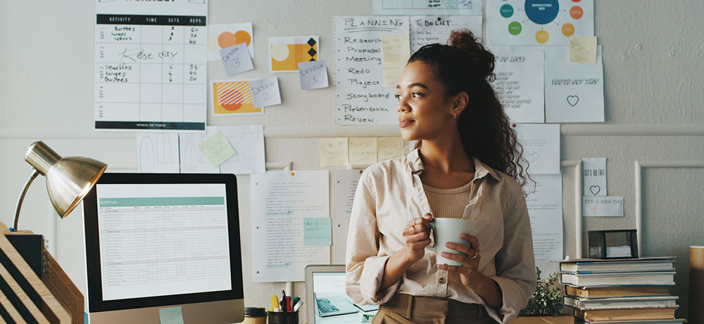 A woman holding a dring in an office