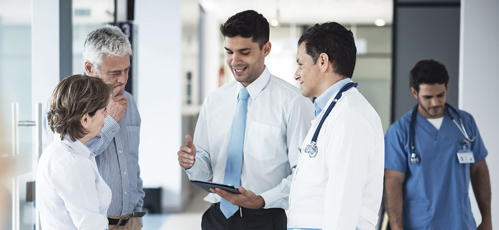 Hospital Executives talking to a doctor