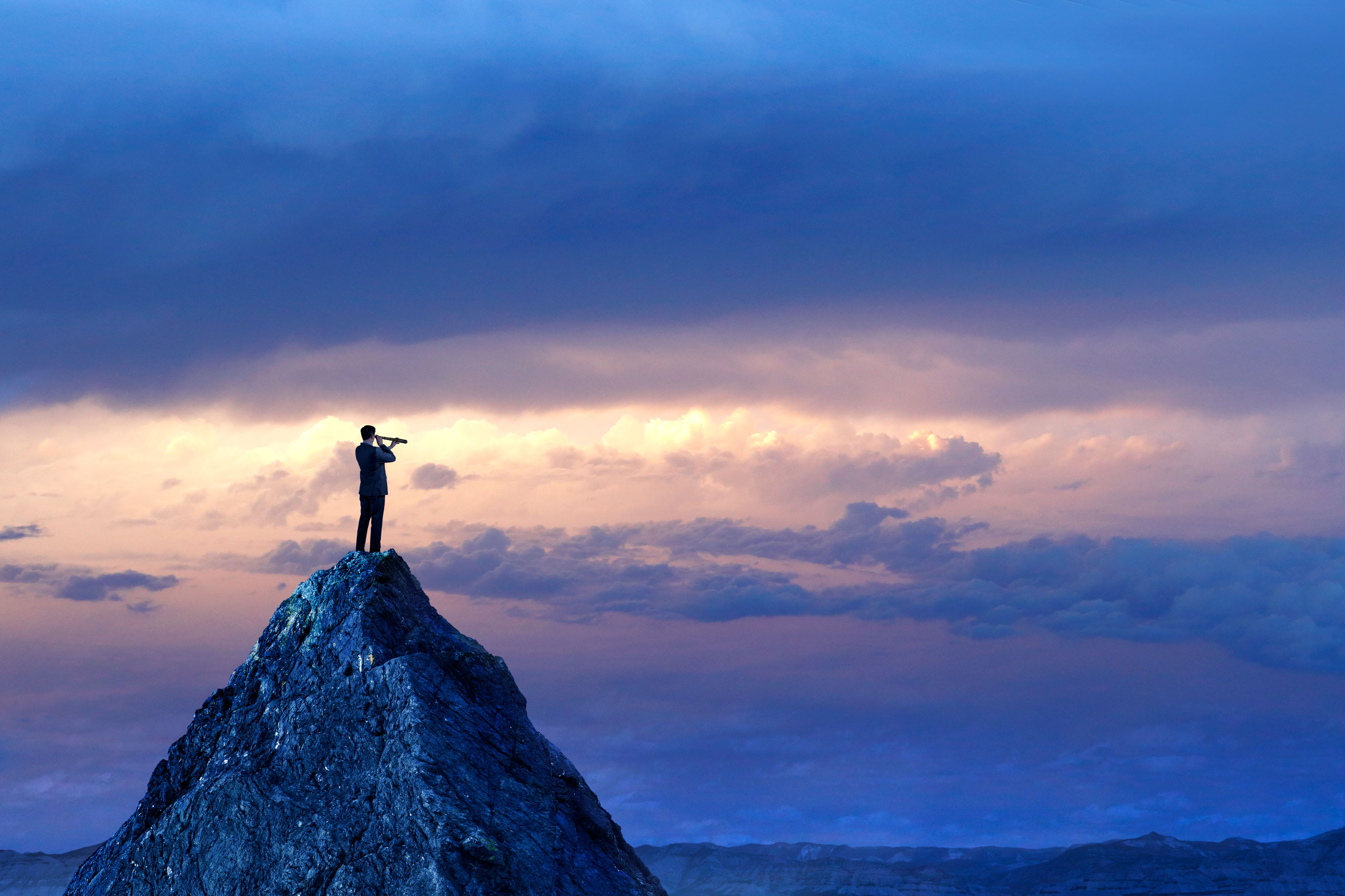 A person looking through a binoculars on a mountain