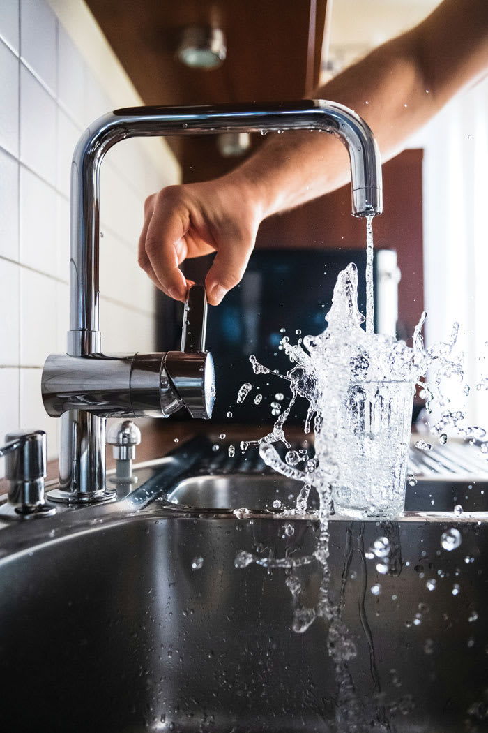 overfilling a glass of water