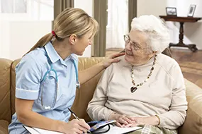 Nurse caring for elderly woman