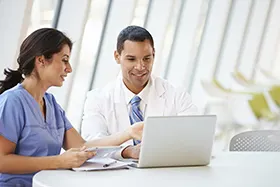 Nurse and doctor doing research online