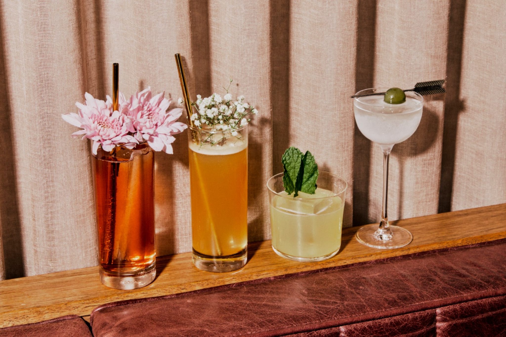 Four cocktails on the bar at Caretaker's Cottage.