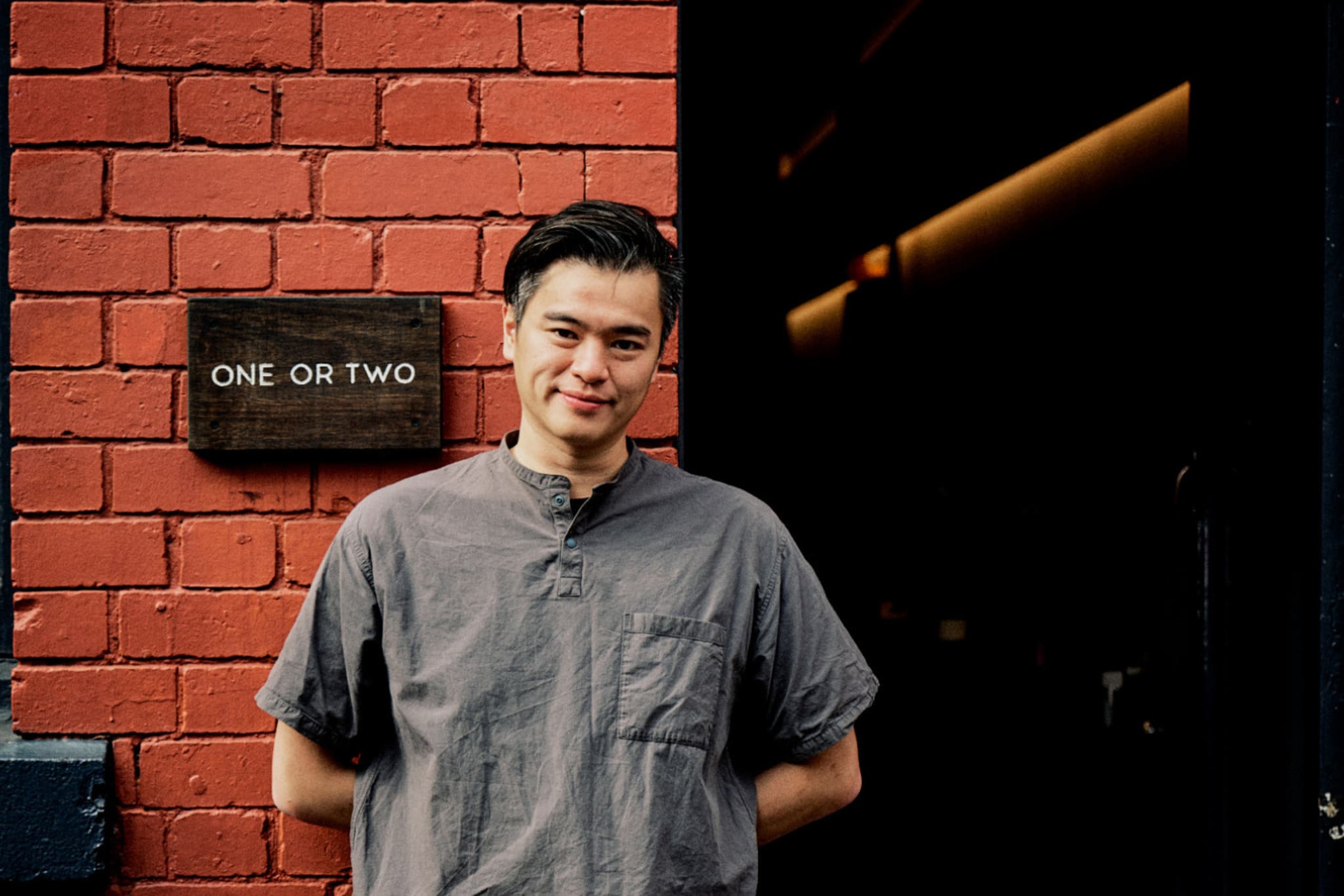 Andy Chu in front of his Bar, One or Two.