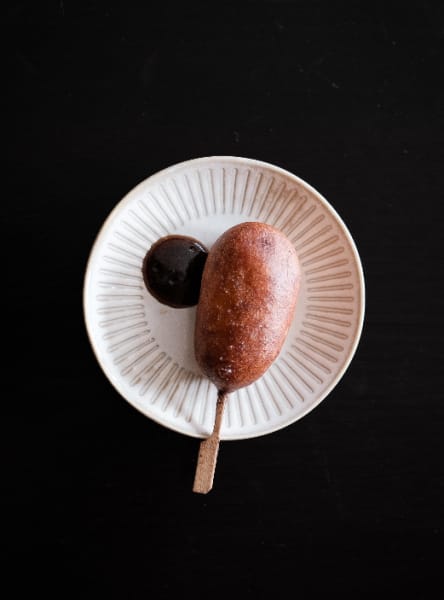 A duck and pickle corn dog with quince ketchup at Maggie's Snacks & Liquor