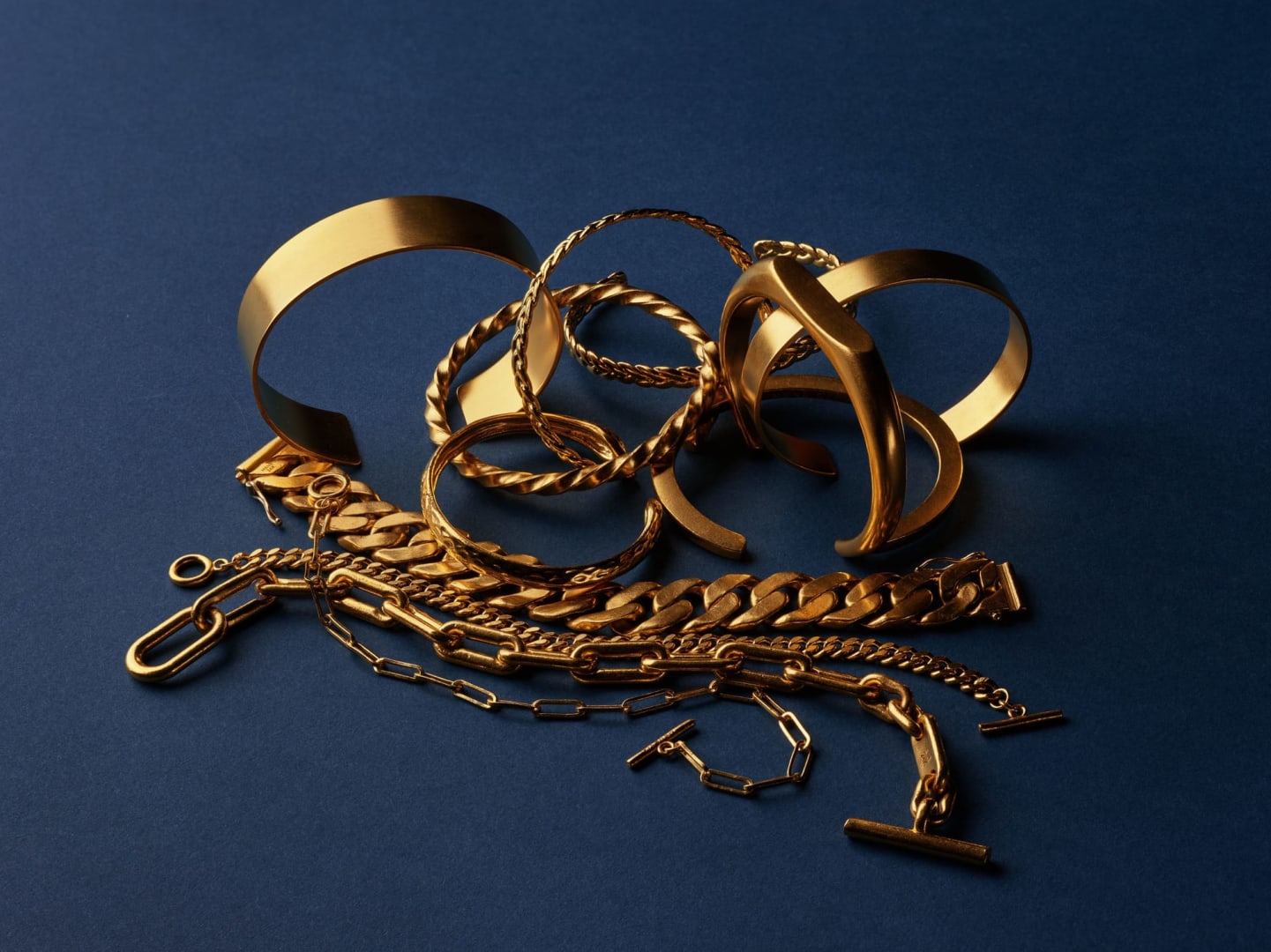 Close-up of 24k gold Menē jewelry showing deep rich gold colour.