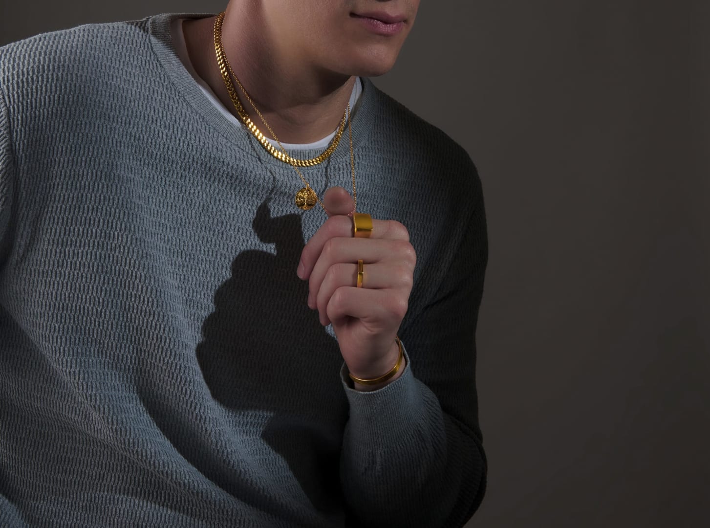 Layered 24k Menē gold chains of varying lengths styled together.