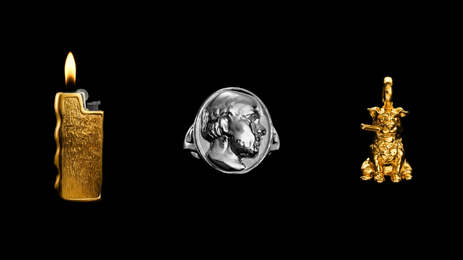  Three pieces from the Nick Foulkes x Menē collaboration displayed together: the Lighter Holder in 24k gold, the Socrates Ring in pure platinum, and the Smoking Dog Pendant in 24k gold.