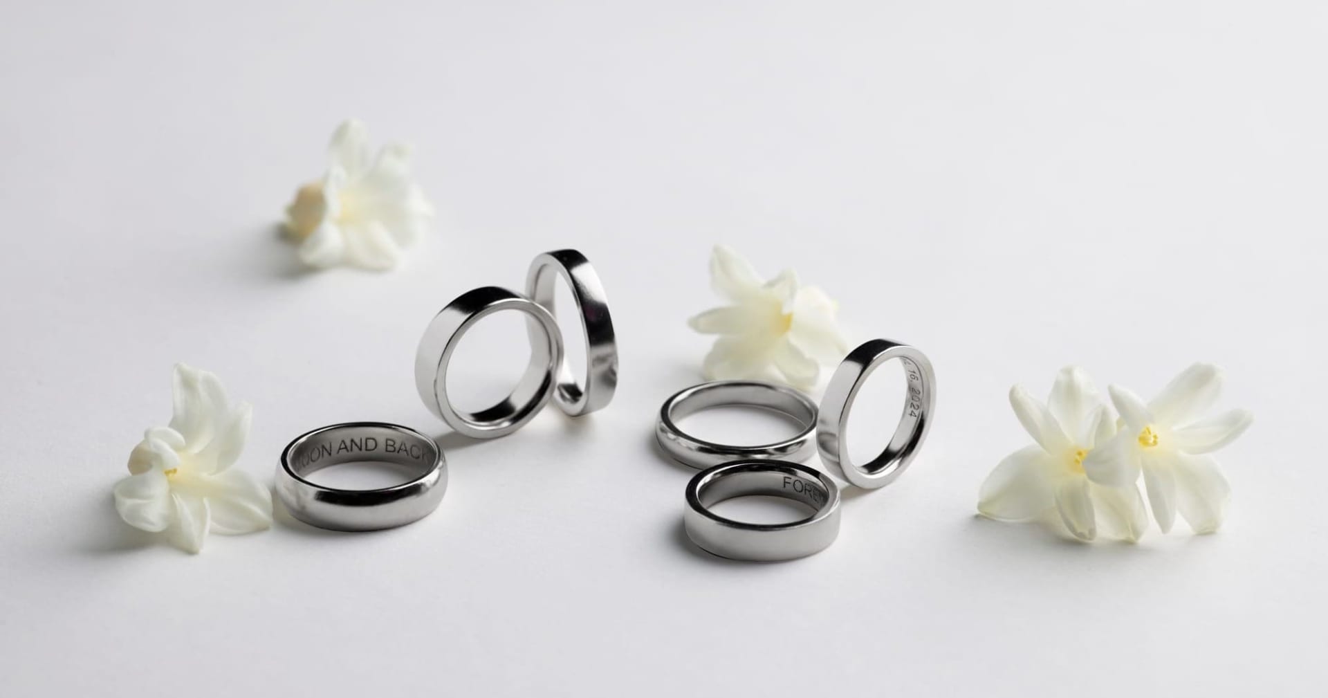 Menē pure platinum wedding bands displayed together, showing the substantial weight and cool luminosity of pure platinum.