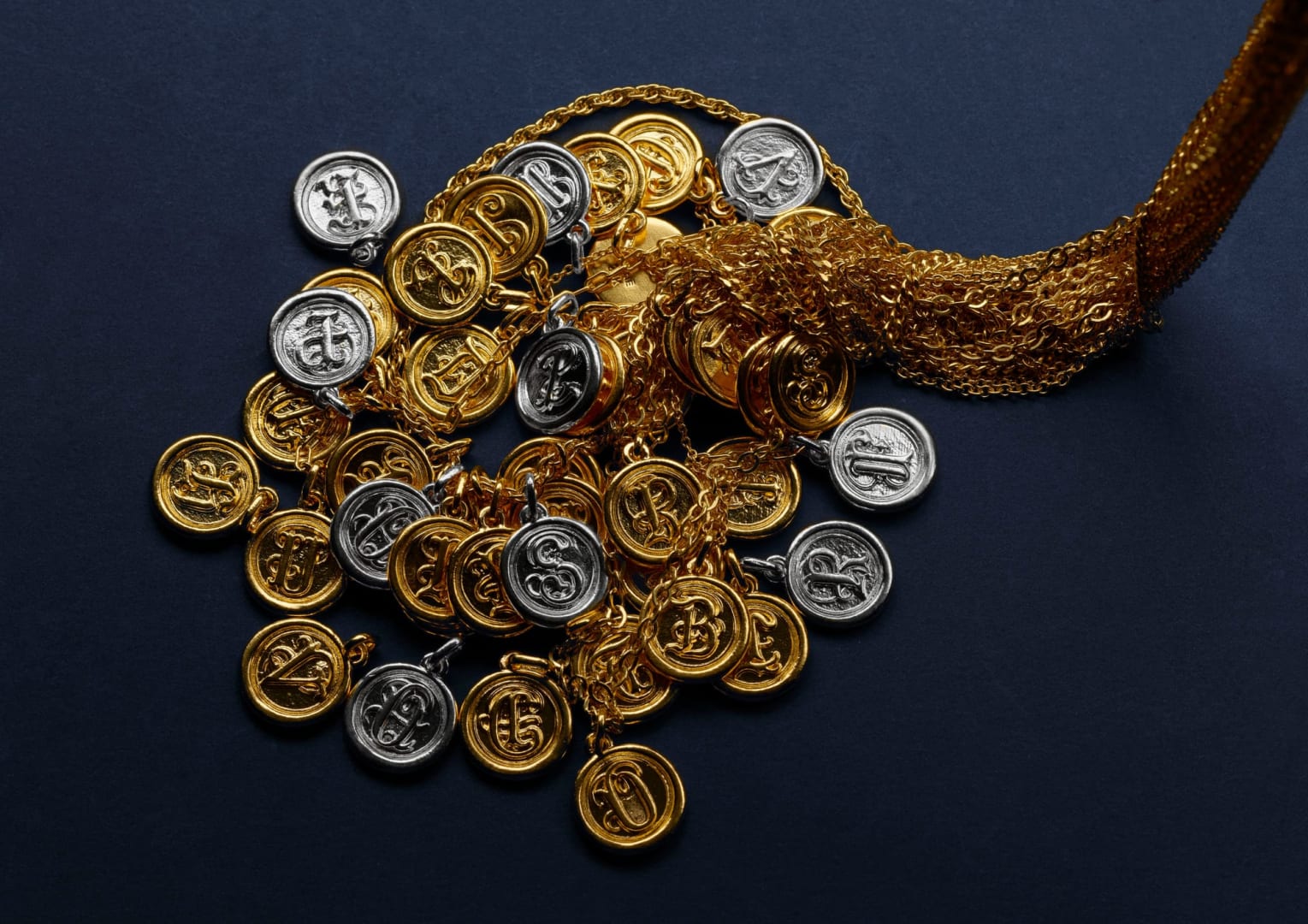 Menē Wax Seal Pendants in 24k gold and pure platinum.