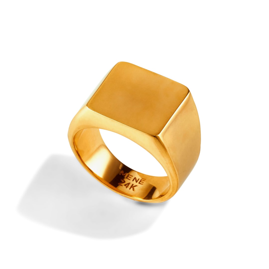 A 24k hallmark stamped on the Menē Square Signet Ring, indicating pure gold purity.