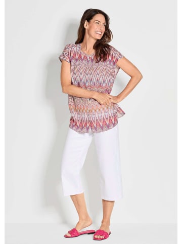 GOLDNER Kurzgröße:  Kurzarm multicolor Printbluse in orange / gemustert