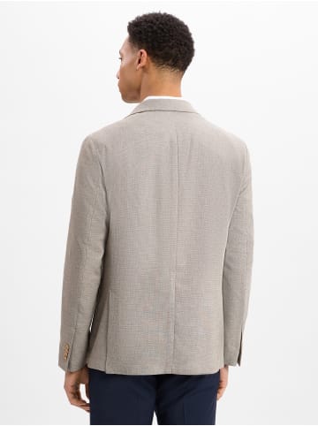 Andrew James Sakko in beige