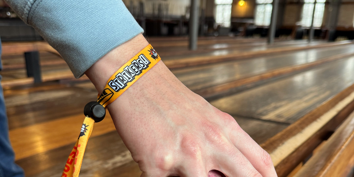 custom cloth wristband being worn at bowling alley