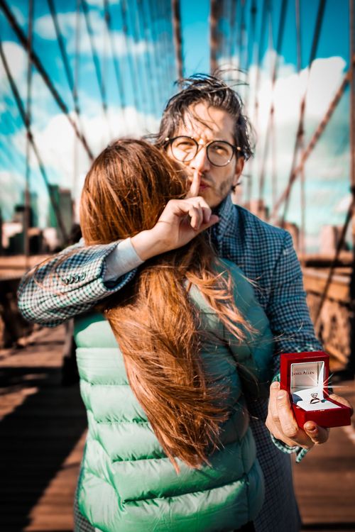 guy holding wedding ring in a red box 