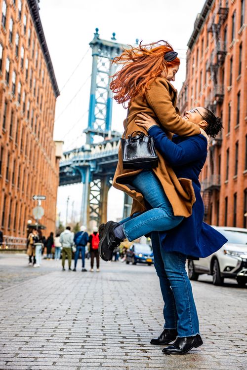 lesbian couple portrait in dumbo with big red hair 