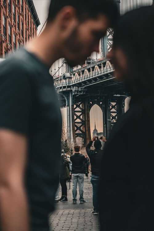 empire state building between 2 people posing 