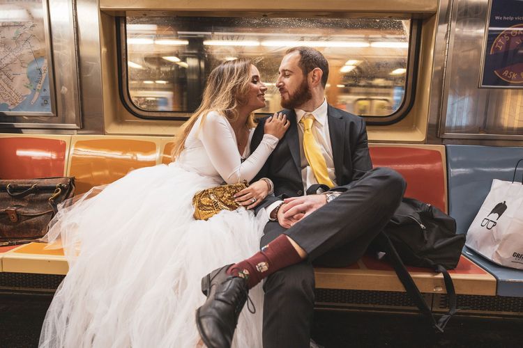 bride wearing big white dress on the subway in New York City 