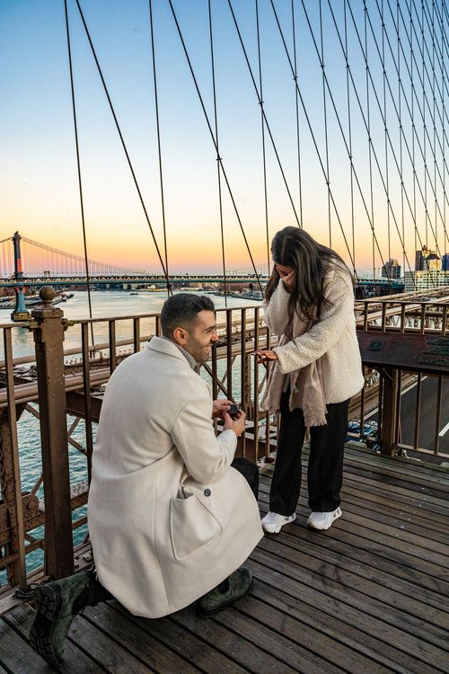 girl on bridge with wedding ring in sunset