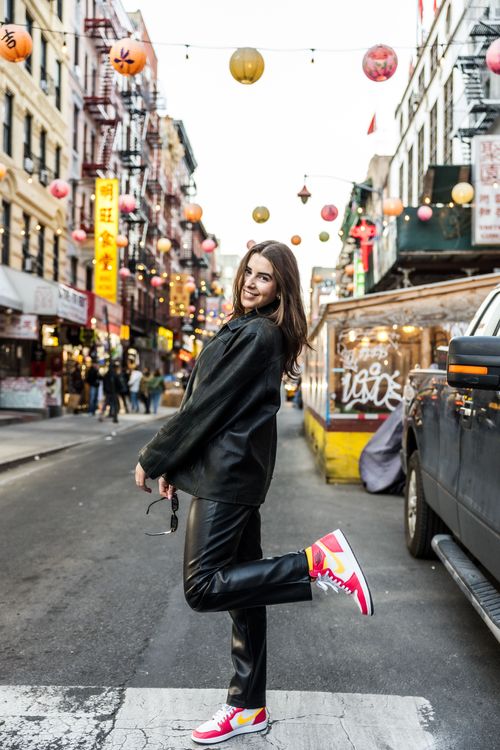 girl wearing nike shoes by china town New York