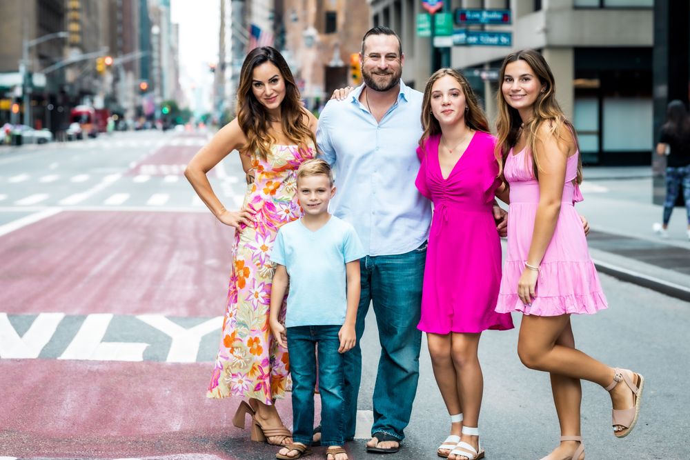 family wearing pink taking pictures in midtown New York City 