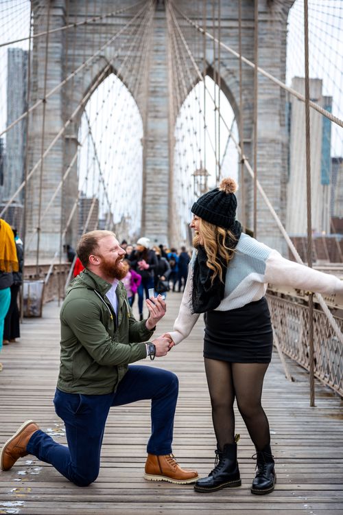 guy standing on one knee holding a wedding ring 