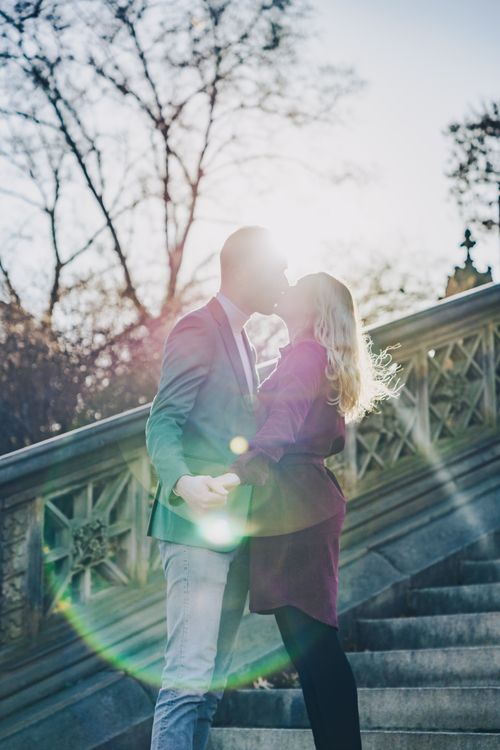 couple standing on the stairs in Central Park by the bethesda fountain in New York City 