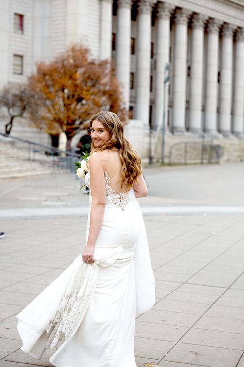 bride wearing big white dress in with hall 