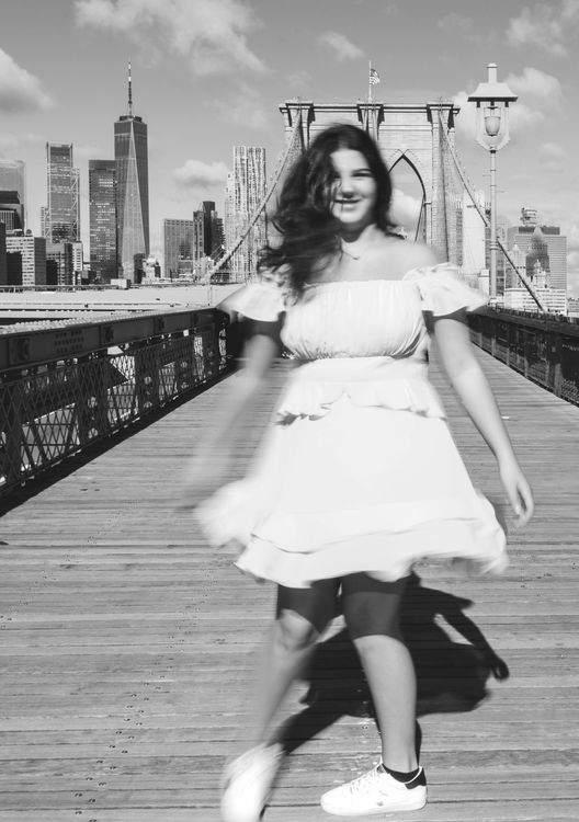 girl wearing dress on Brooklyn Bridge long exposure 