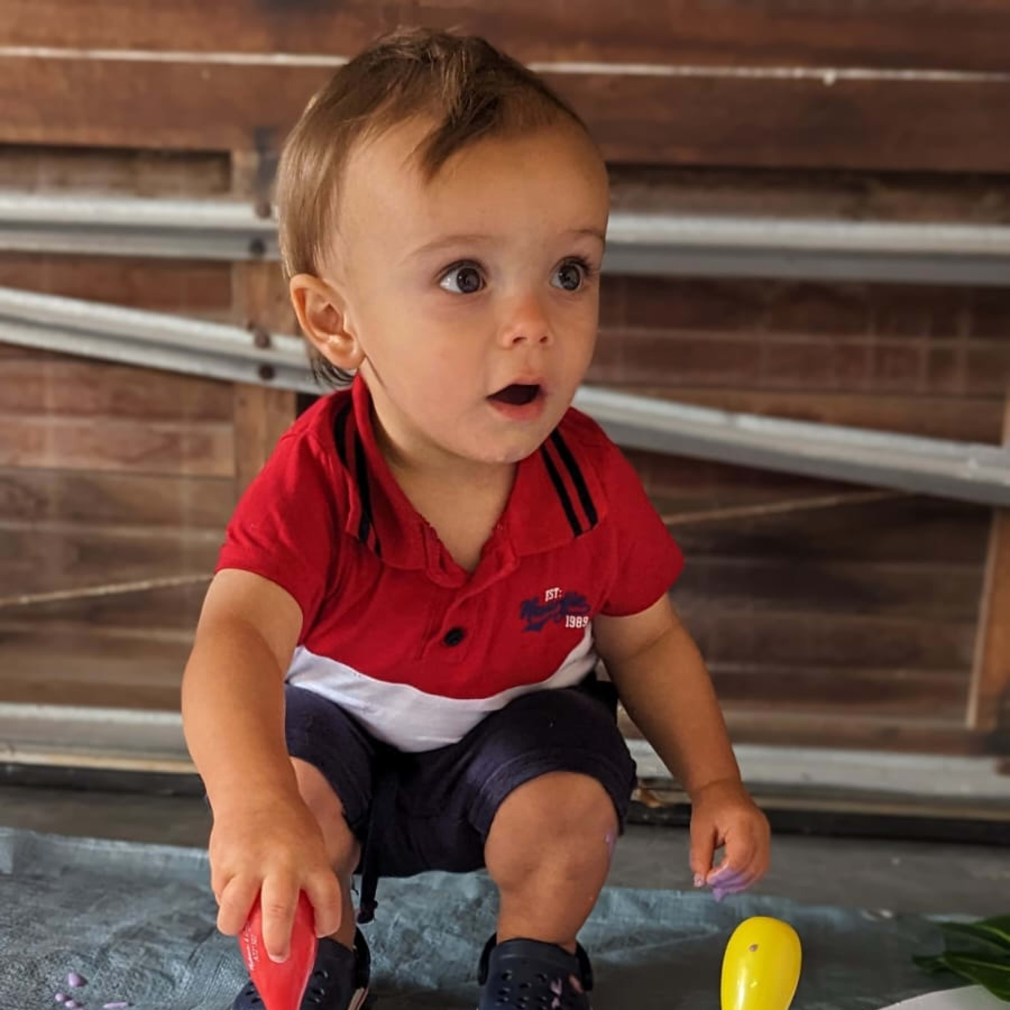 Child painting at messy play workshop