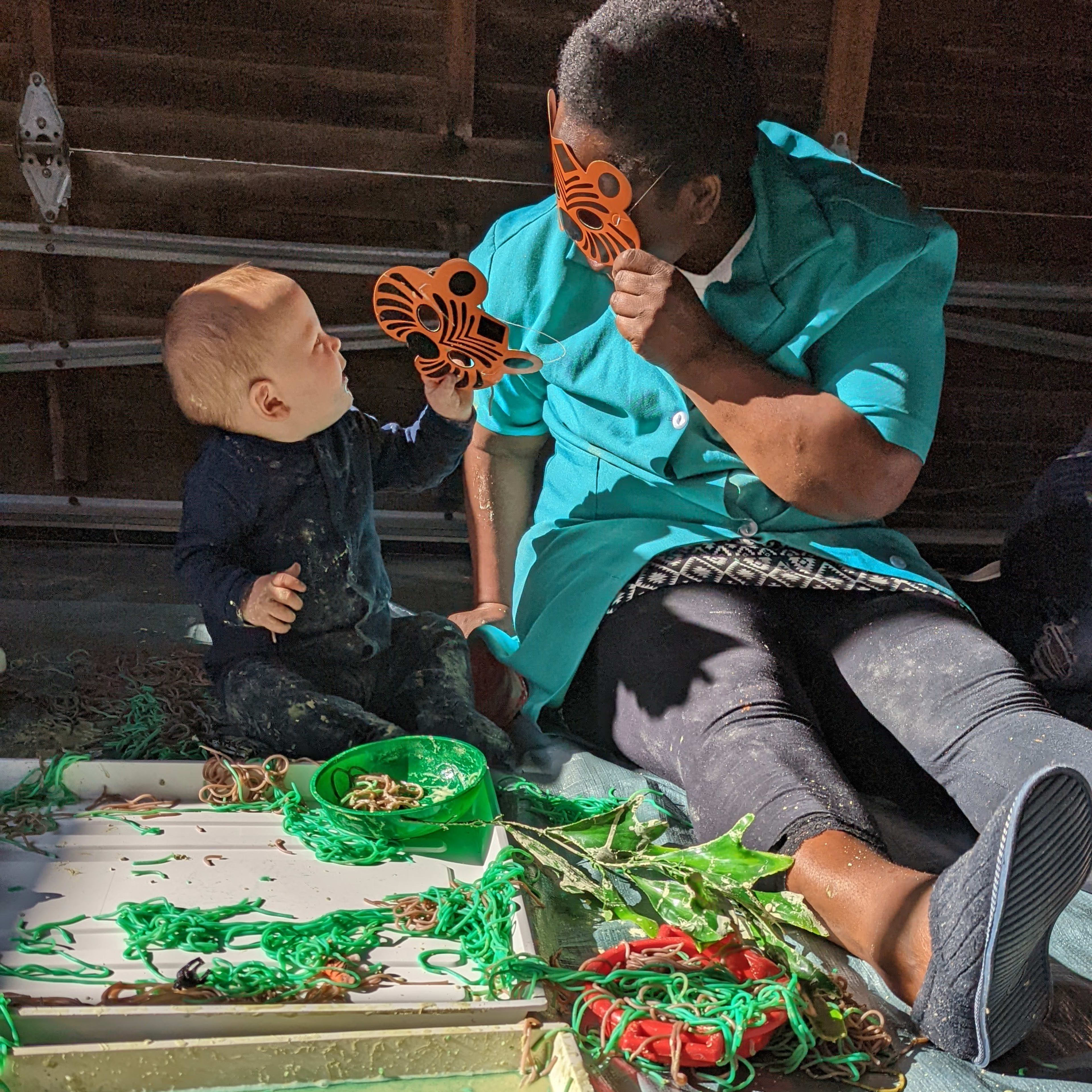 Boy and nanny having fun with tiger masks