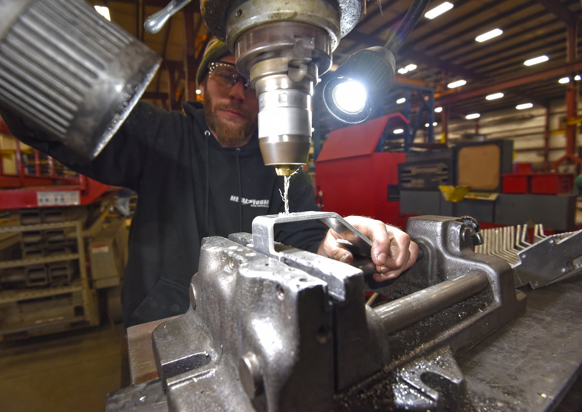 Metal fabrication using a drill press while fabricating a custom metal part