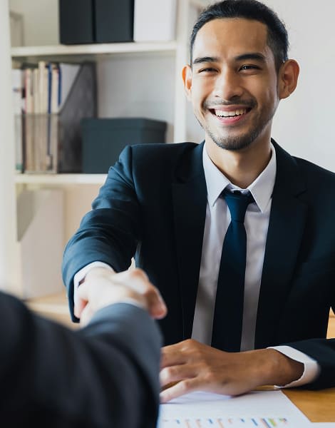 Man smiling while handshaking a lawyer referencing immediate help