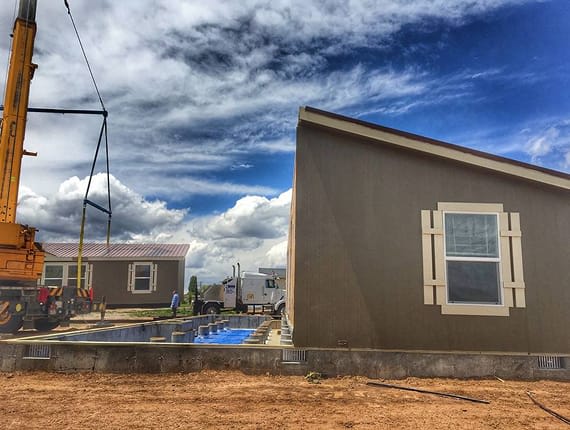 Manufactured home being installed on foundation blocks