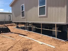 Manufactured home raised on blocks during relevel service