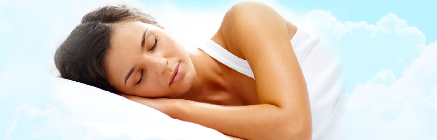 Woman peacefully sleeping while floating in a dreamlike sky, representing restful sleep and tranquility
