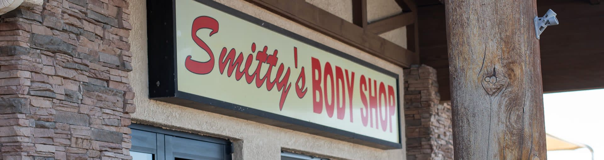 The main sign for Smitty's Body Shop hanging over our entrance