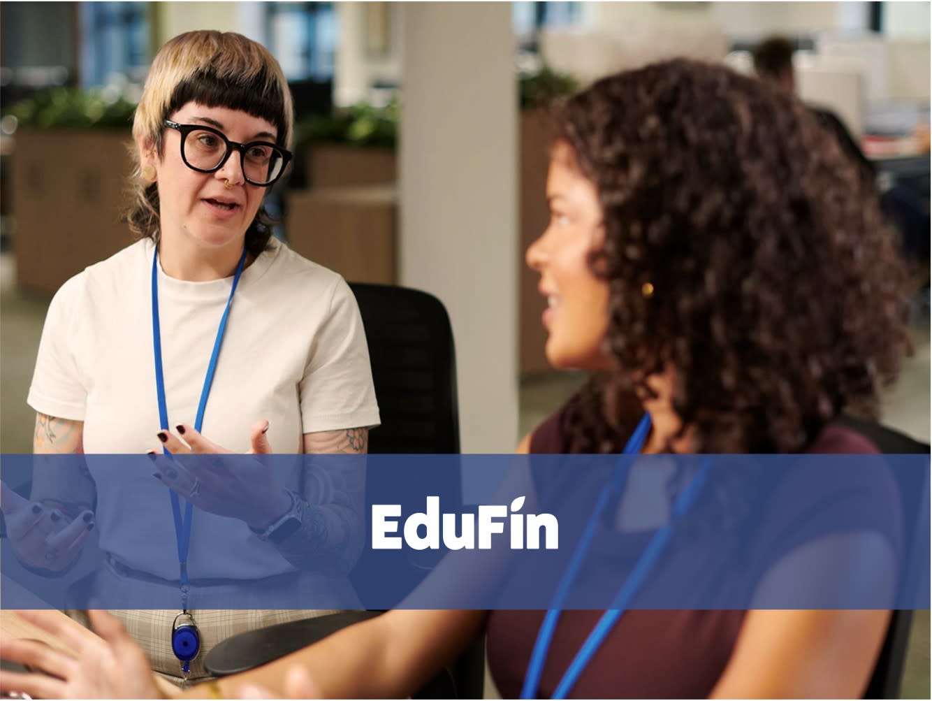 Two women talking in a modern office.