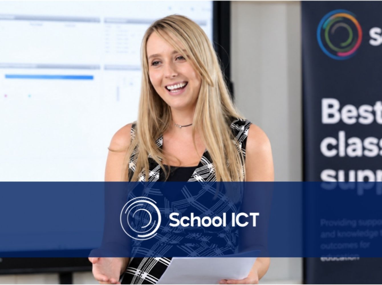Woman presenting to a classroom in front of an interactive whiteboard
