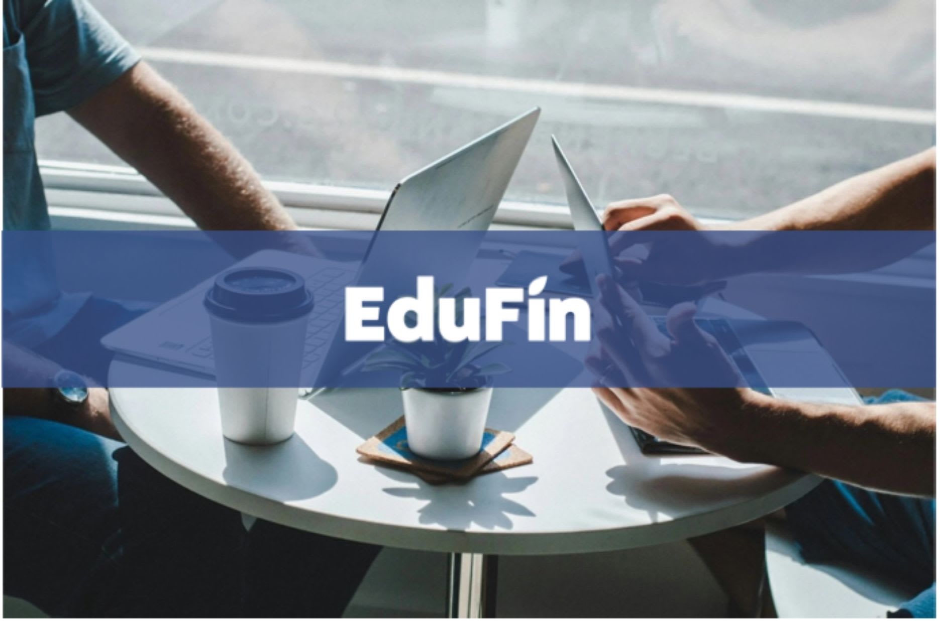 Two people sat around a coffee table working on laptops