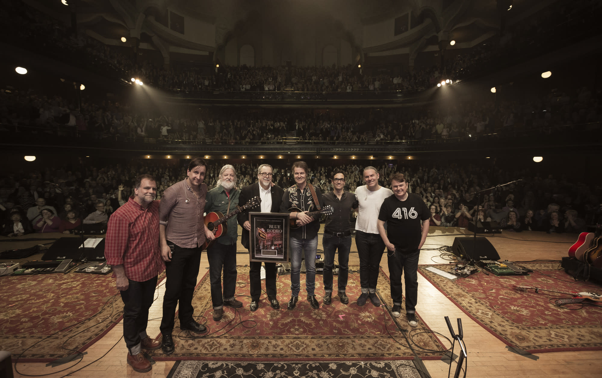 Deane Cameron with Blue Rodeo on stage at Massey Hall
