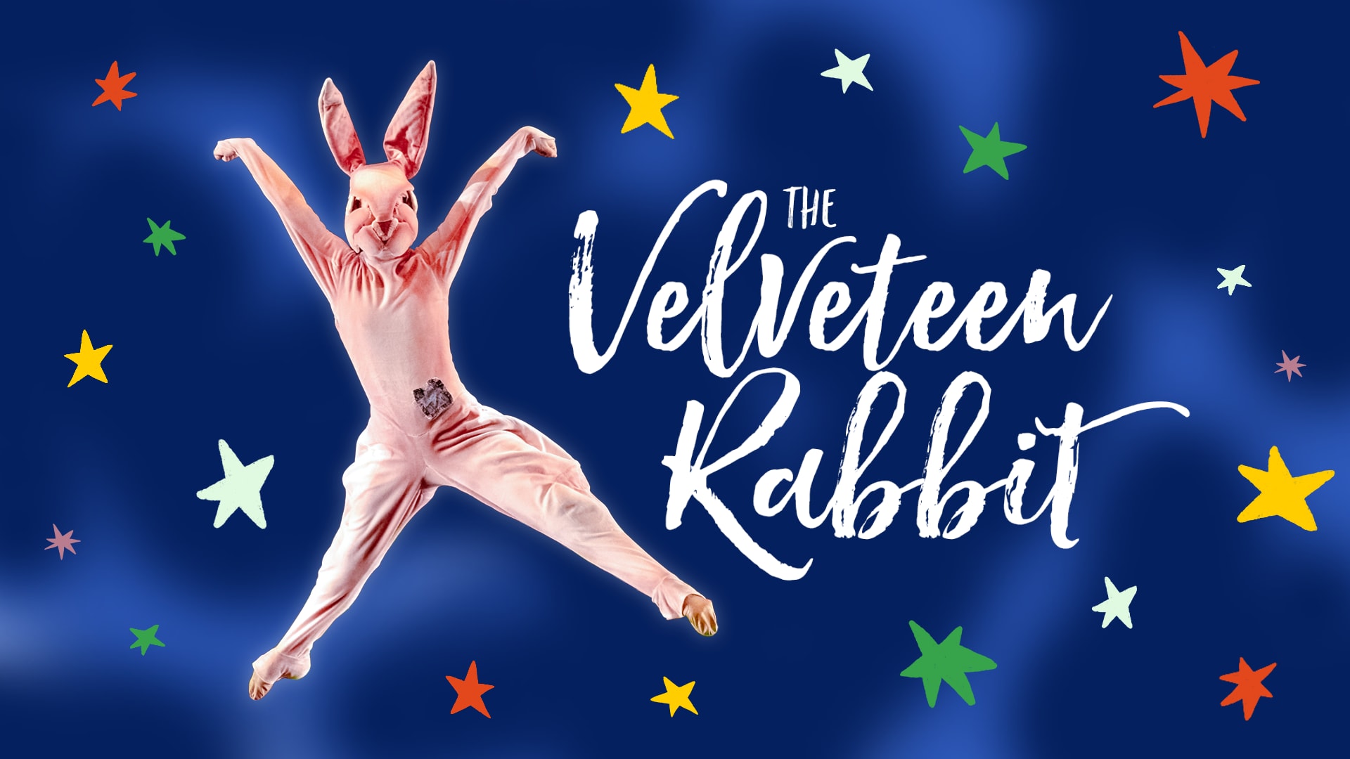 The Velveteen Rabbit jumping next to the The Velveteen Rabbit logo against a dark blue background with colorful stars