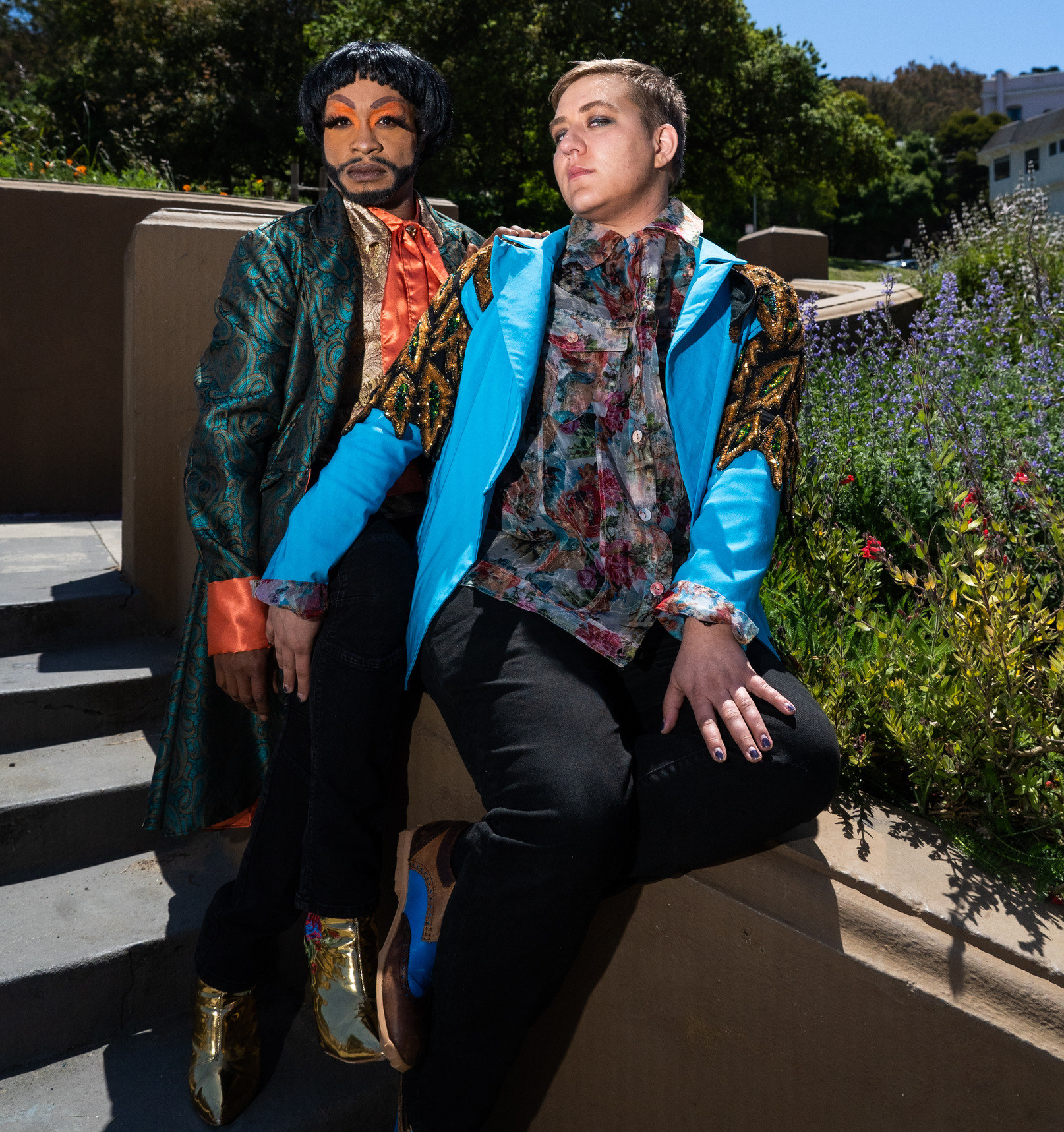 Two actors in funky clothing looking seductively into the camera