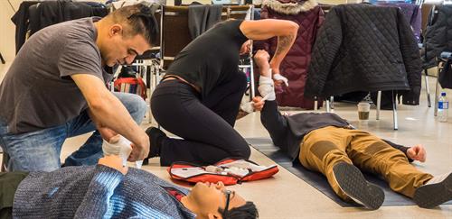 Students learning bandaging skills in a Red Cross Standard First Aid class