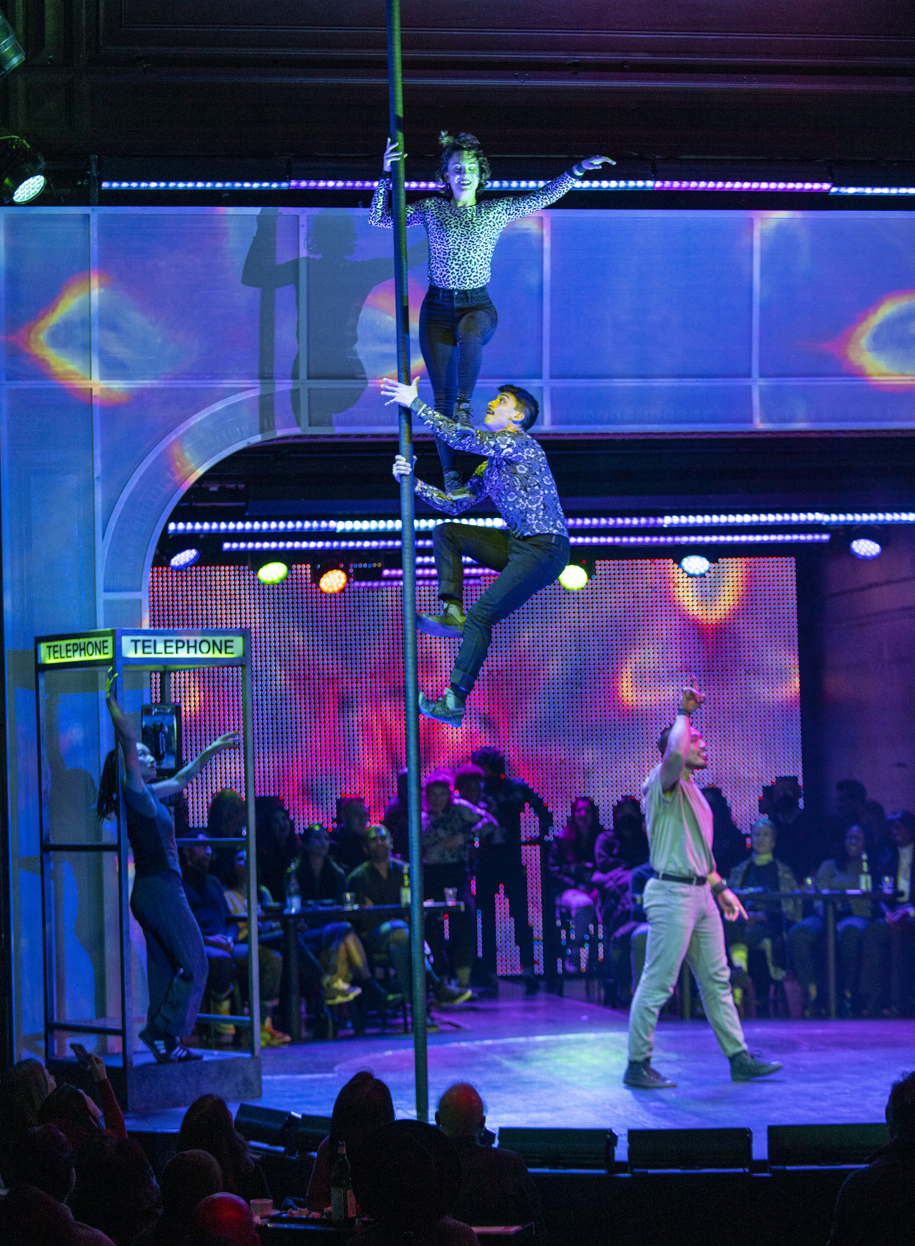 Acrobats climb up a Chinese pole during a Dear San Francisco performance