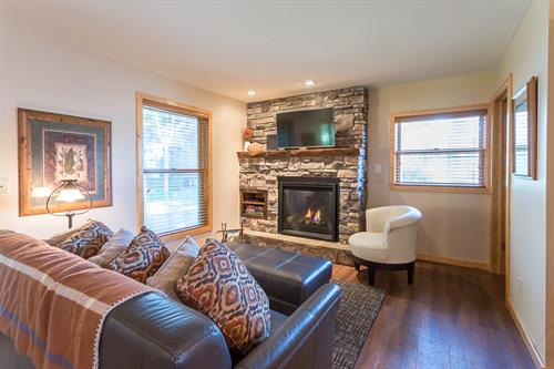 Interior living room with stone fireplace.