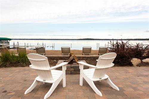 View of the lake by a lakeside firepit.