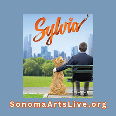 A man on a park bench with his dog