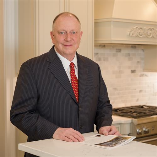 Stewart Woodward a Realtor/Broker standing in a kitchen at an open house for a home he is selling